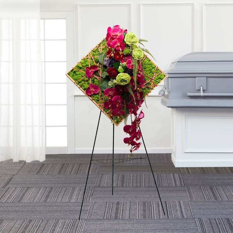 Pink and green modern sympathy displayed on an easel in a funeral home