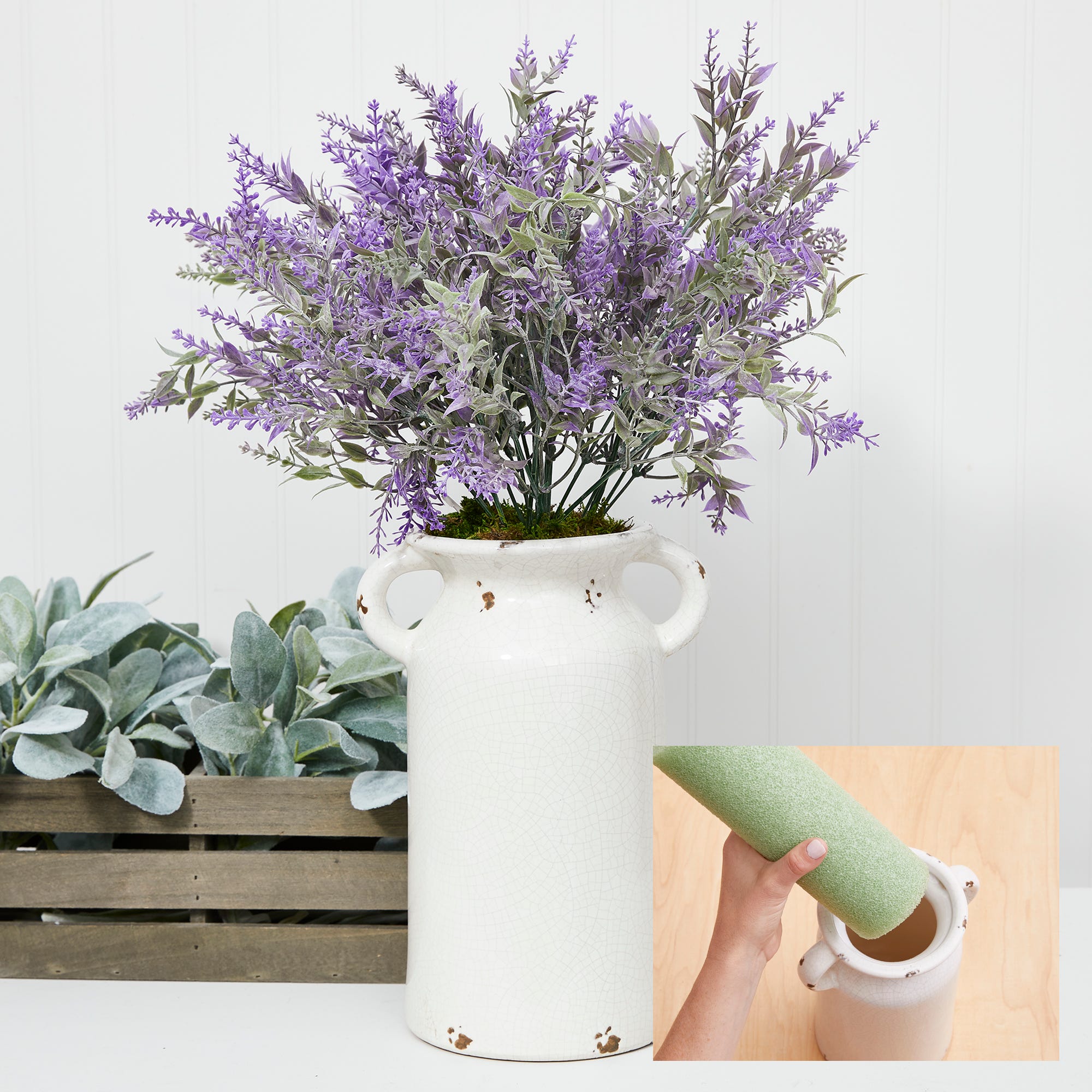 Purple fowers and green stems in a white heirloom vase designed with green floral foam