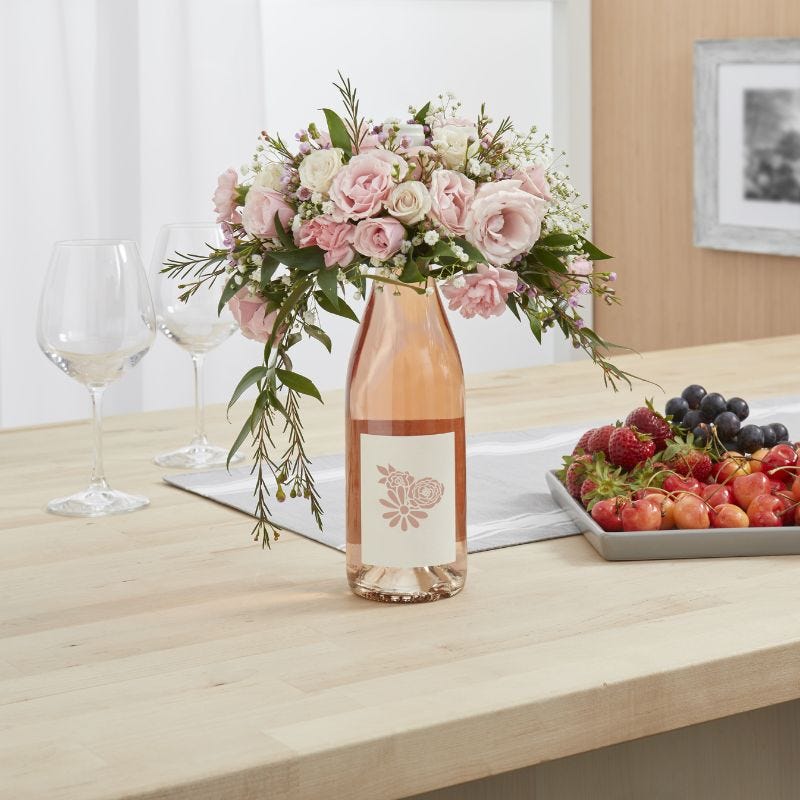 A wine bottle bouquet serves as a table centerpiece before becoming a gift Mom will love for Mother's Day